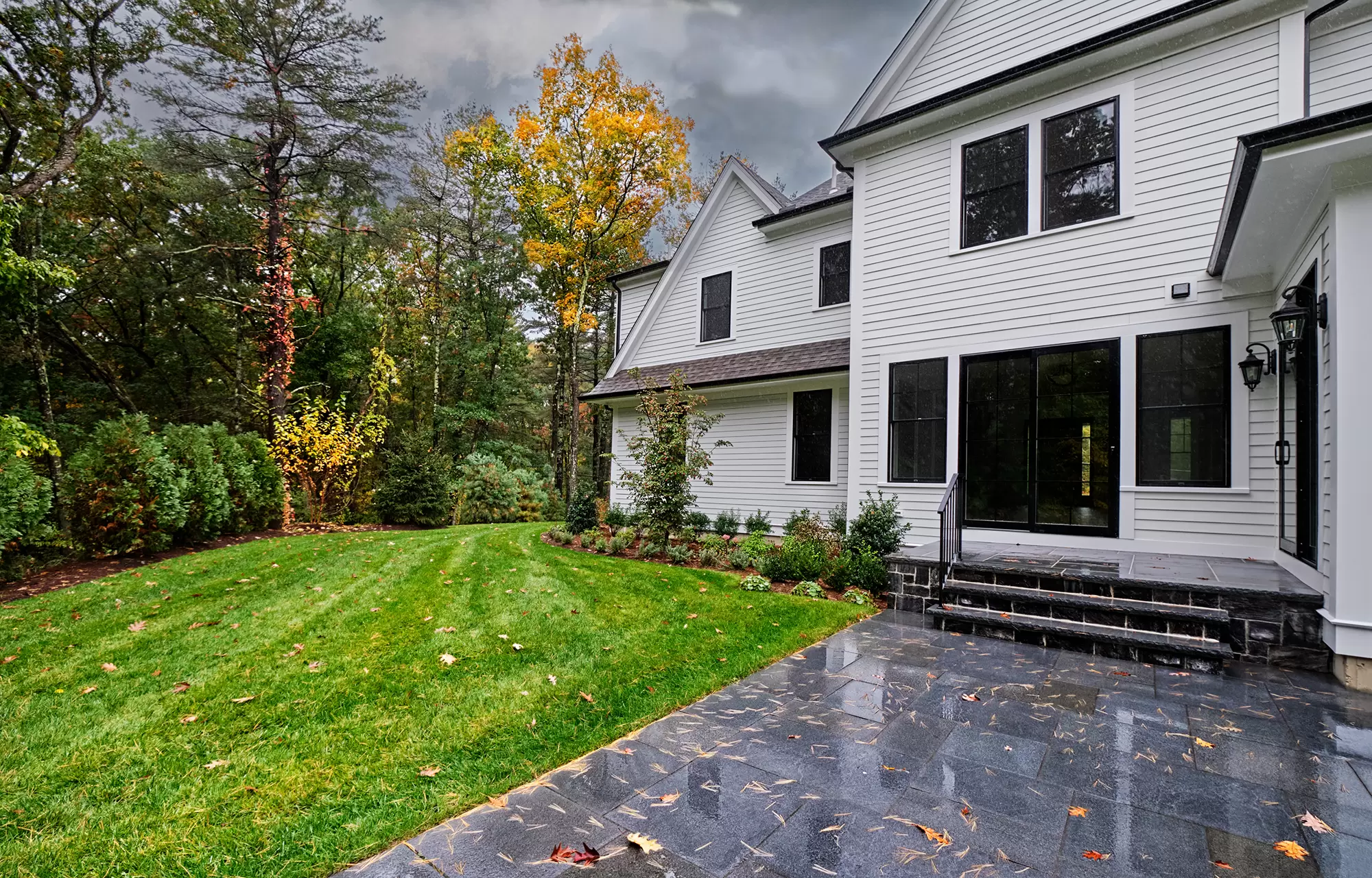 Front yard of a home under an overcast sky.