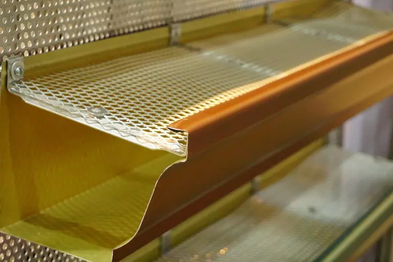Close-up of yellow colored gutter guards.