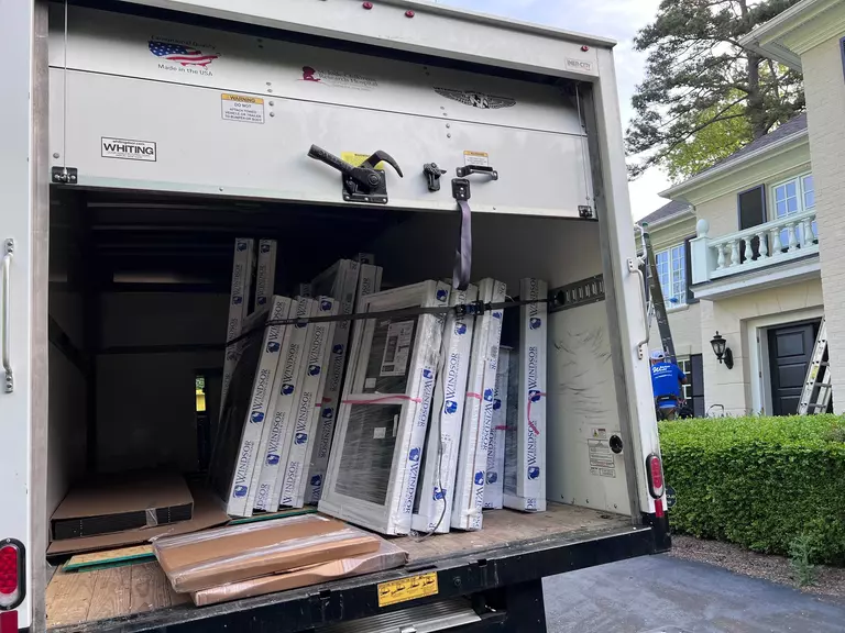 The interior of a truck with lots of windows, ready for installation.