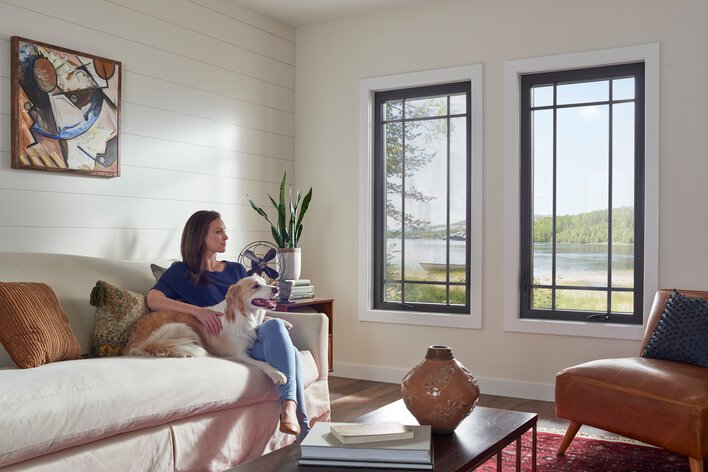 Sustainable home remodeling, like the eco-friendly windows featured in this living room, can dramatically reduce your carbon footprint. 