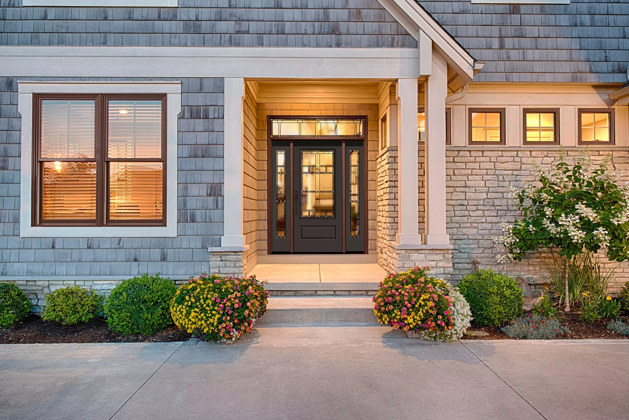 Front of a home with a dark gray door and several square windows.