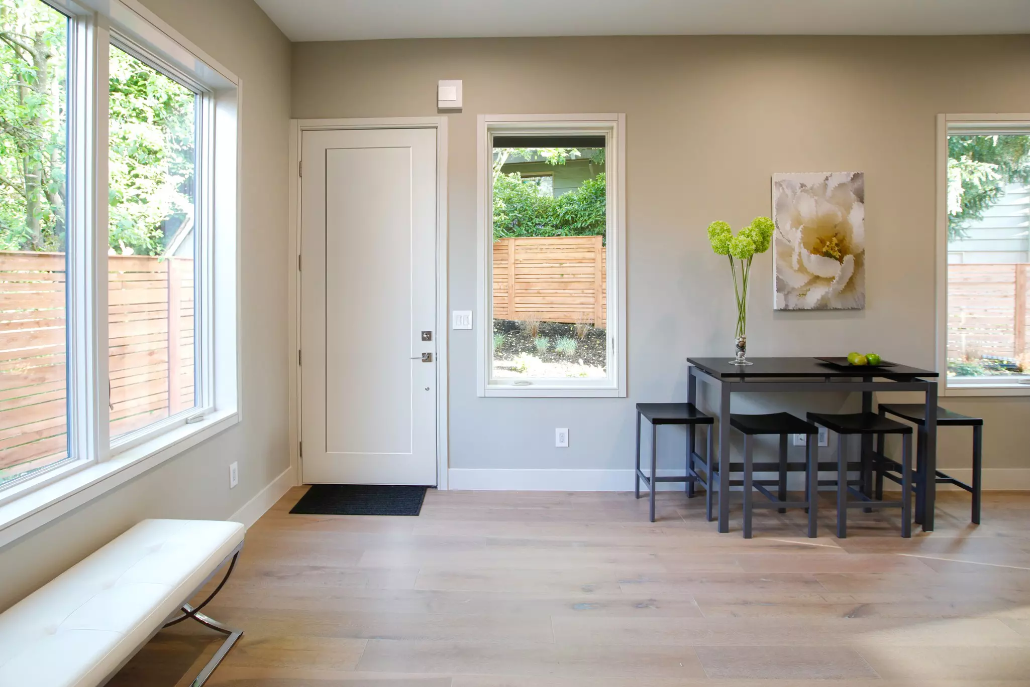 White entry door beside white windows.