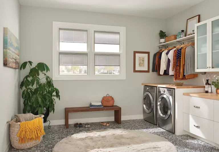 The mudroom of a home with two windows.