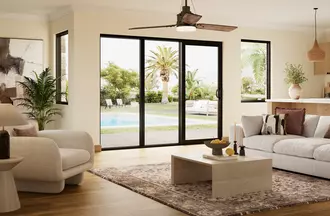 Bronze sliding patio door in a cozy living room with a pool in the background
