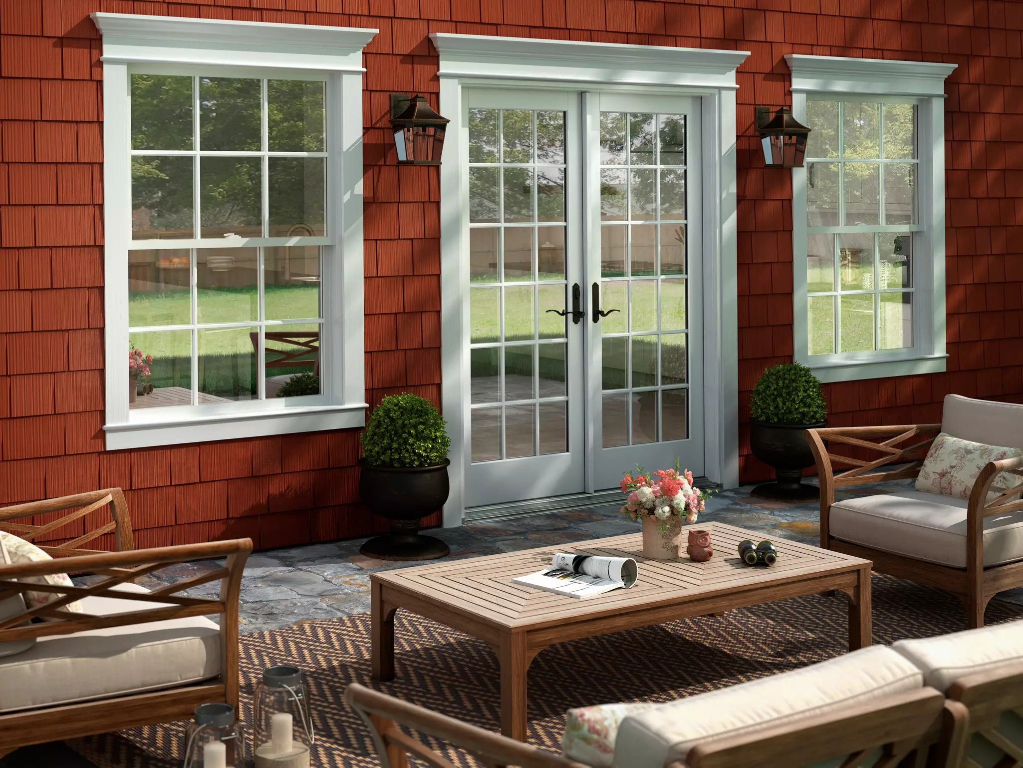 White patio doors shown with double hung windows and traditional back deck in view with table and chairs.