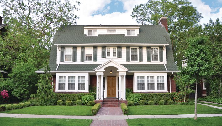 House with white siding and gray shutters, a popular house and shutter color combination.