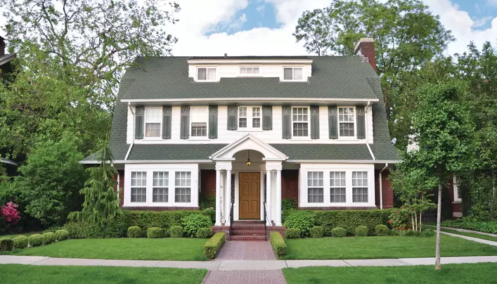 House with white siding and gray shutters, a popular house and shutter color combination.