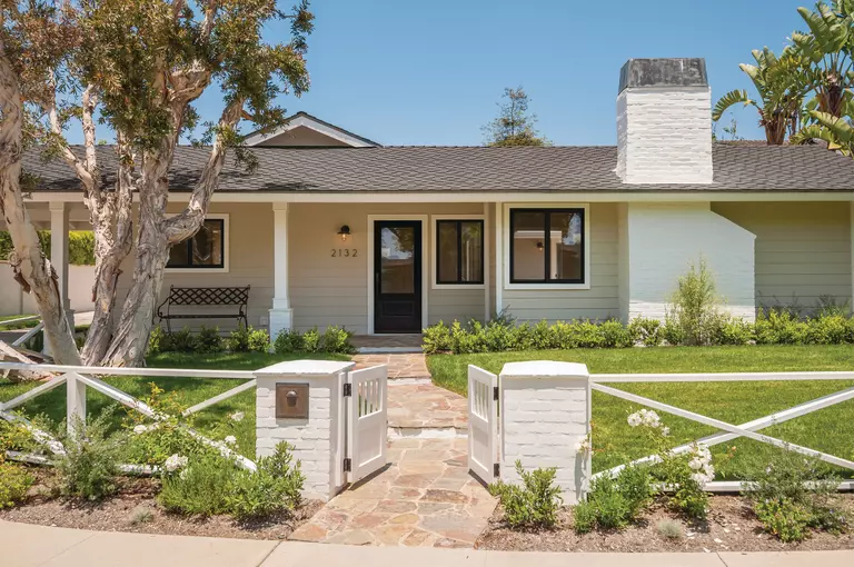 Front of a home with a swinging gate.