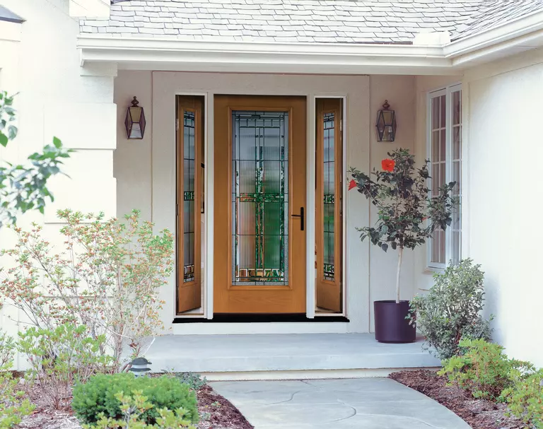 A front door viewed from outside with opened sidelites.
