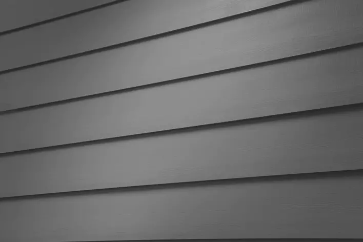 Close-up of gray insulated vinyl siding on a house