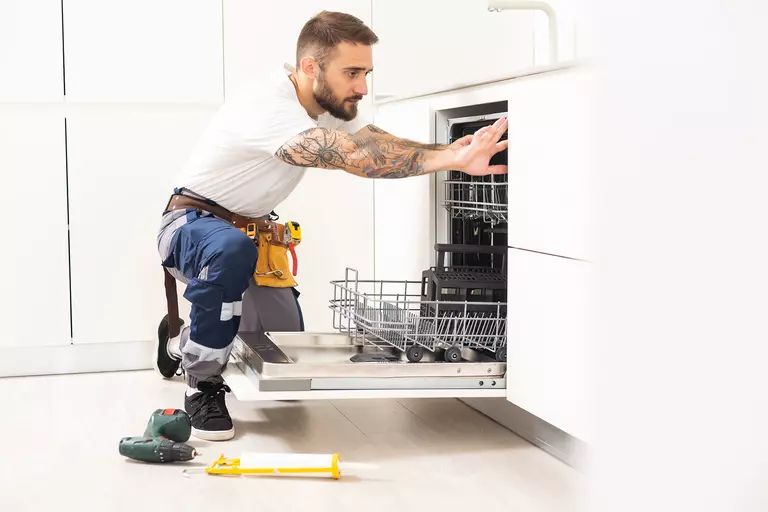 A contractor installing new appliances for a home renovation project. 