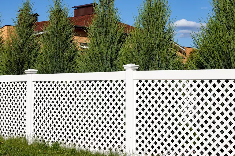 White lattice panels surrounding a home providing increased security and privacy.