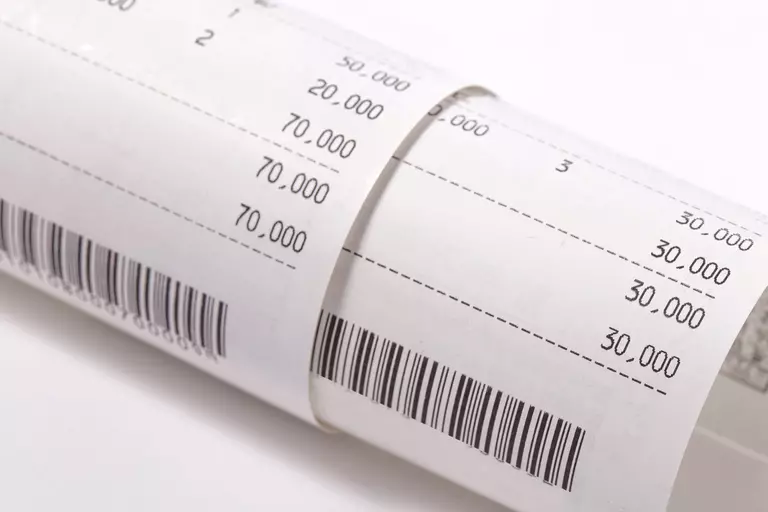 Two receipts rolled up together showing the total prices.