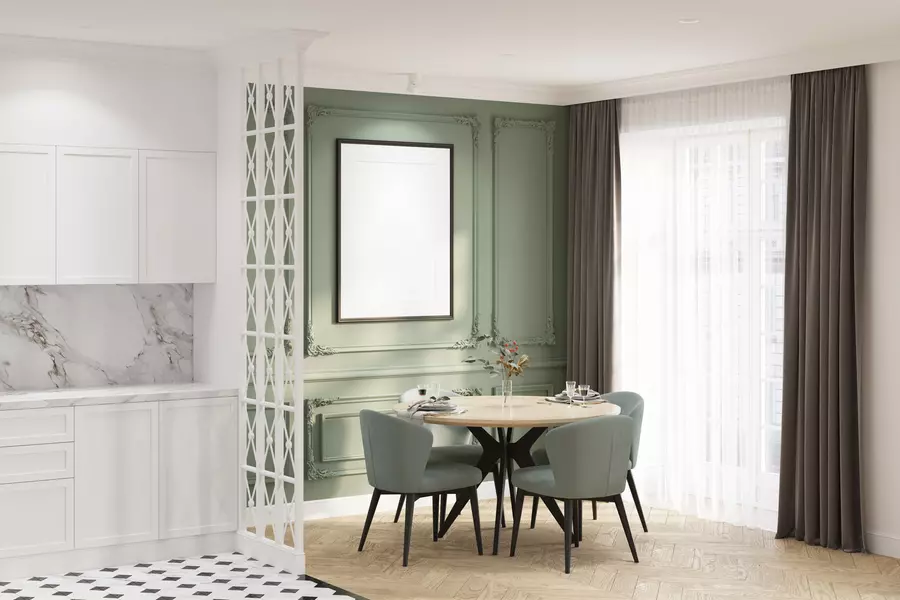 A classy breakfast nook next to tall windows with floor-length curtains
