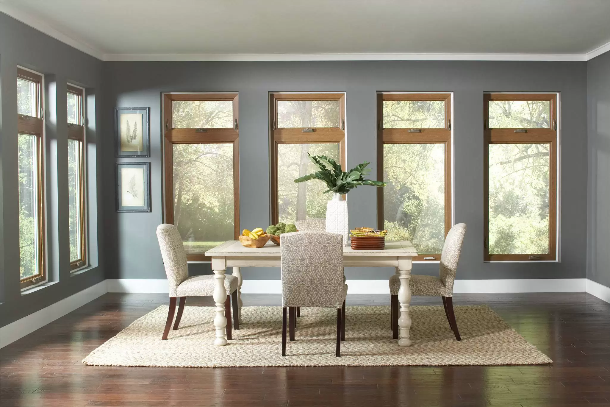 Casement windows with a backyard view in a dining room.