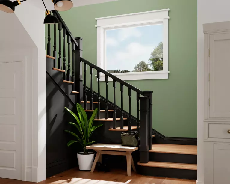 Staircase in a home with a picture window inside a wall.