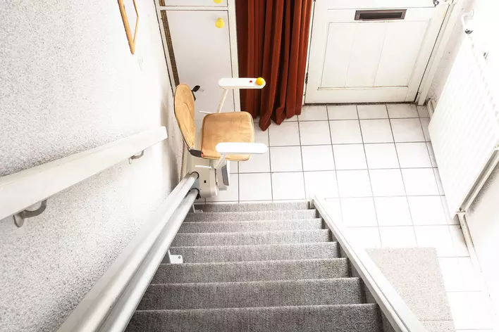 A chair lift connected to the stairs of an age-in-place home so that tenants can get
upstairs.