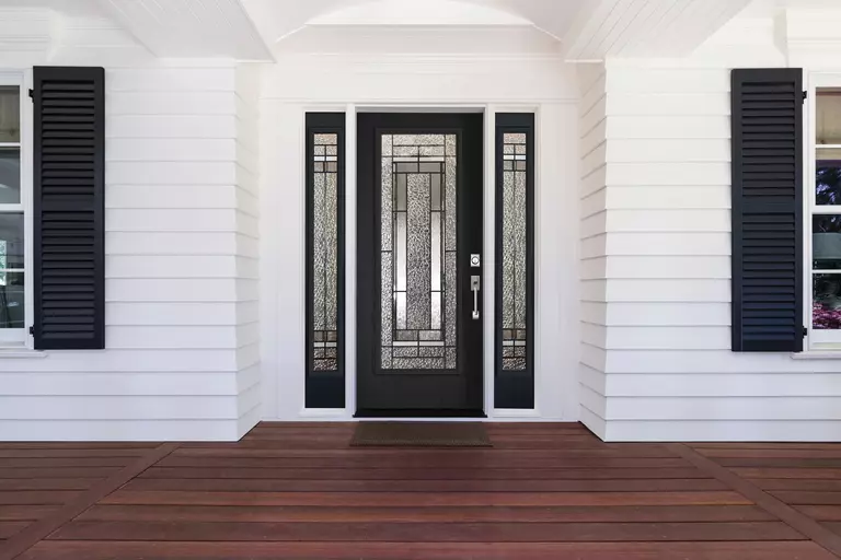 Black woodgrain front door with sidelites featuring several glass textures and grids.