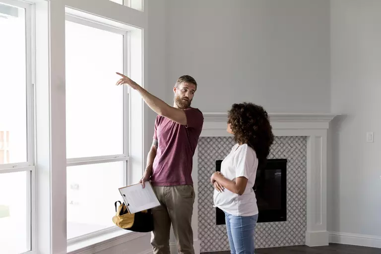 Man showing new windows that were installed on a house to a prospect