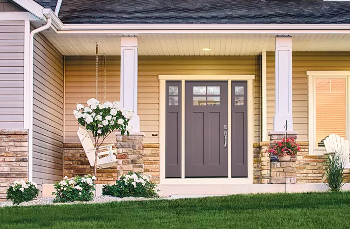 A gray Smooth-Star Entry Door on a 2-story under a porch with a swing nearby