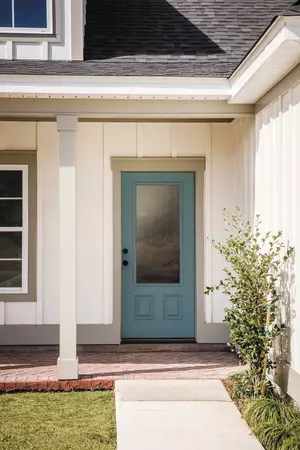 Farmhouse home with a 3/4 lite, 2 panels door style and Rain glass, prefinished in custom color
