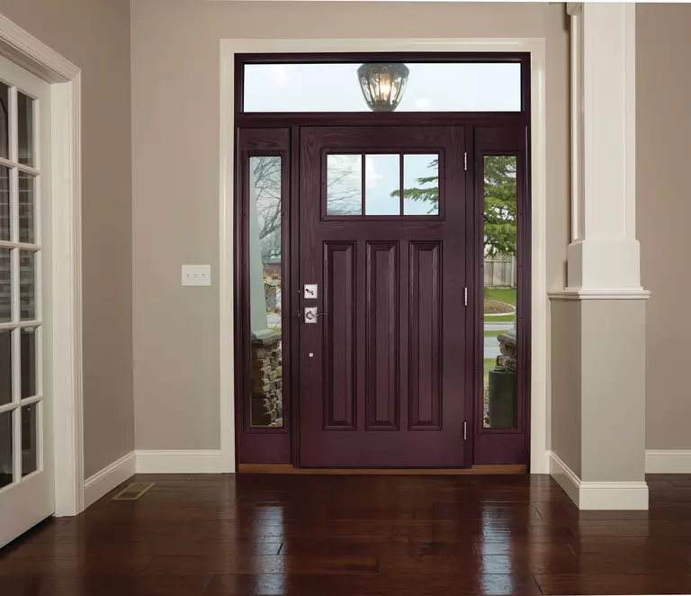 Interior of a home entryway with a dark red front door and full glass sidelites.