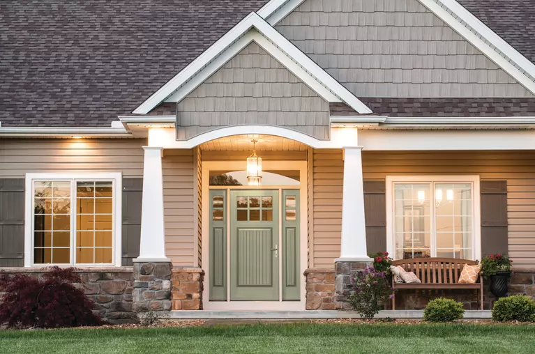 Front view of a home and its green front door.