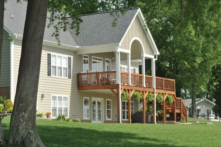Two-story home with tan vinyl siding.