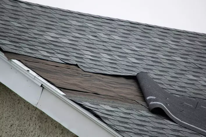 A closeup of roof damage from a storm