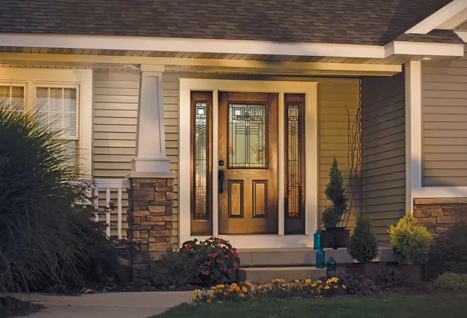 Premium Textured Fiberglass door in Oak, with a 1/2 Lite, 2 Panels door style and Heartland glass, with a Camelot Handleset in Aged Bronze
