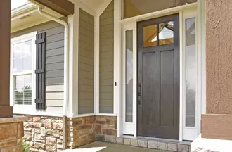Window World Woodgrain Entry Door in a natural oak stain with a full lite that has monterey glass. Plymouth handleset and deadbolt in aged bronze.