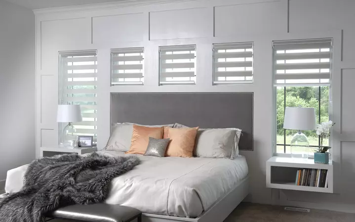 Wood-clad direct set windows with primed interior and prairie grids in a bedroom