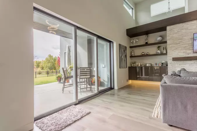 A multi-slide patio door in a living room that is fully closed with a covered porch on the outside