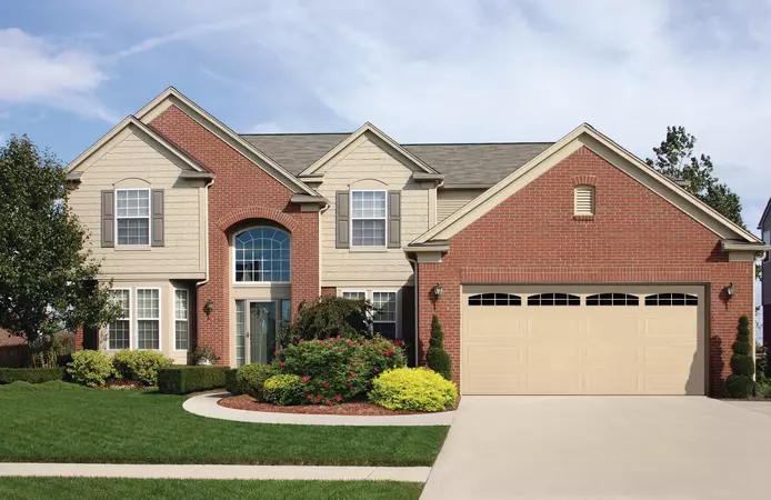 Almond ranch panel garage doors with cascade windows