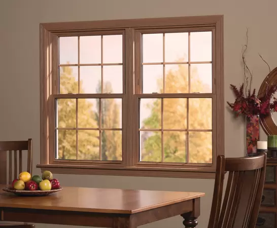 Restorations series Woodgrain double-hung windows in front of a dinning room table