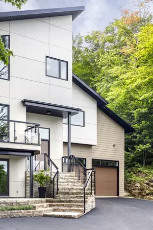 Large modern home with hardie plank and panel in Artic White and Khaki Brown