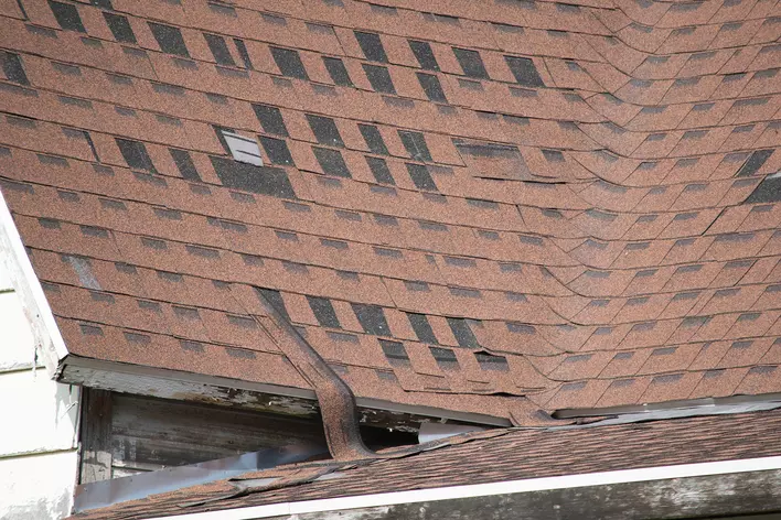 Missing brown asphalt windows on the roof of a home, indicating the need for replacement.