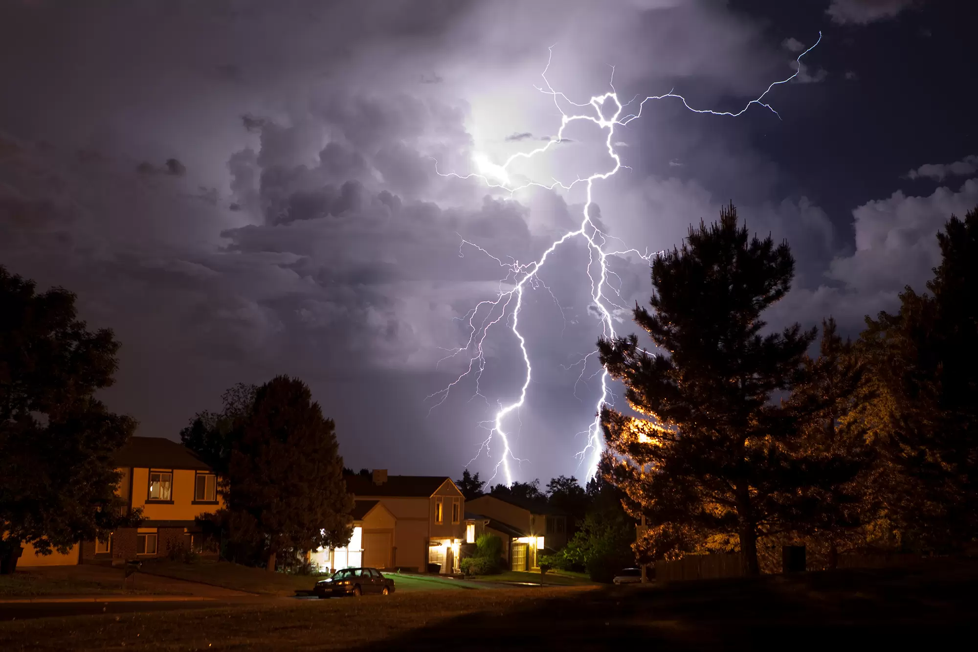 Lightning strike over a suburban neighborhood.