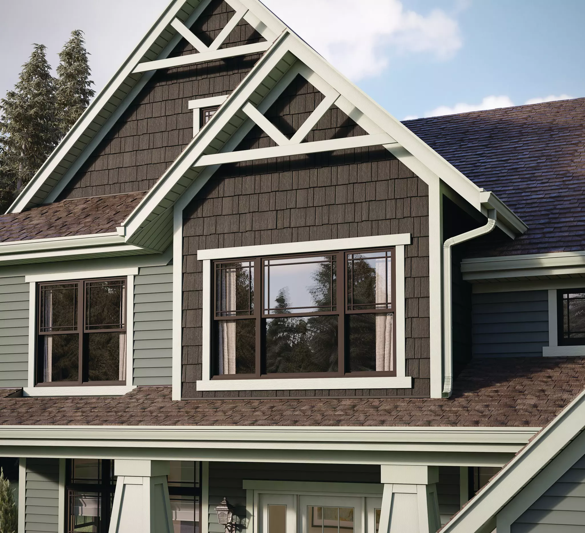 Upper story of a home using wood shakes with light-green siding.