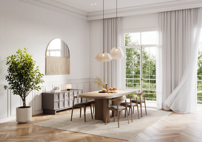 Dining room table in front of glass patio doors in a room with high ceilings.