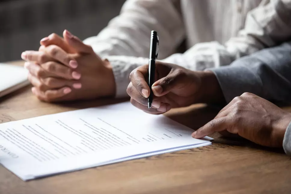 Couple signing business contract together