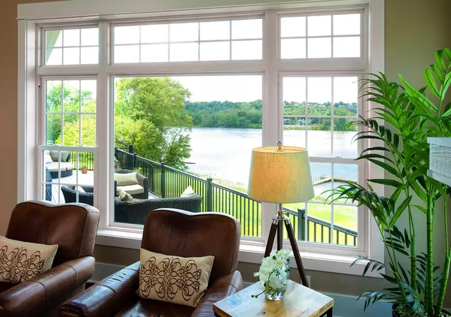 Double hung and picture windows in living room with river view