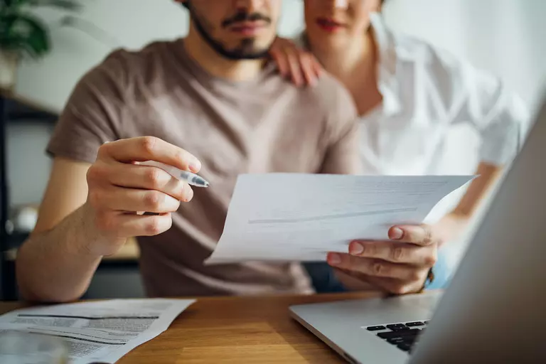 Man and woman looking over paperwork.