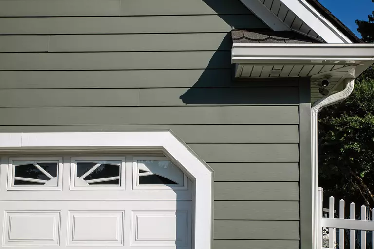 Side of a home with dark gray vinyl siding.