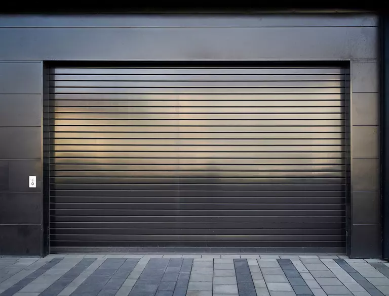 Aluminum garage door attached to an industrial building.