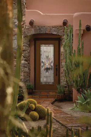 full lite woodgrain entry door with mohave decorative glass on a home with stucco and stone accents