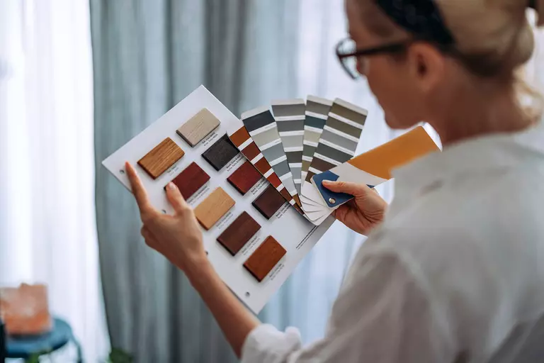 Woman looking at color and material swatches.
