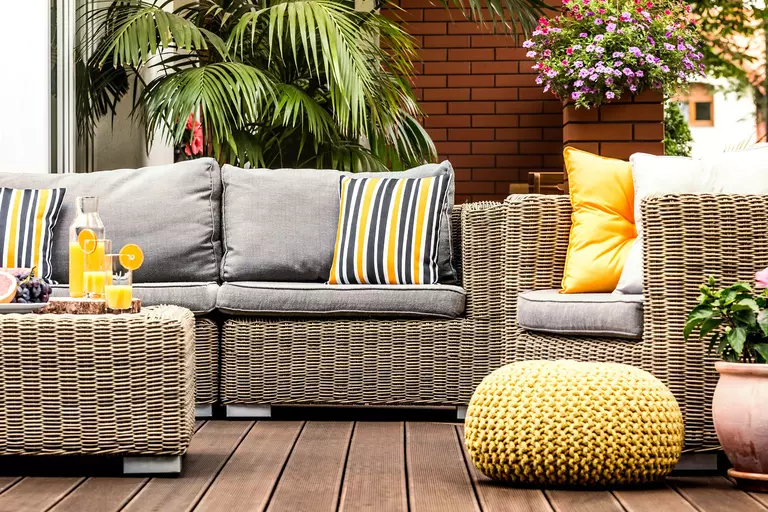 A coastal home with a sleeping porch out back that creates a cozy, aesthetic gathering place.