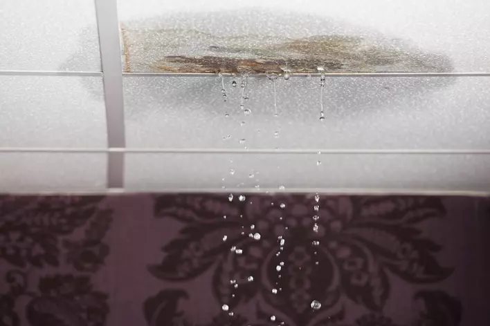 Water damage and leaks in the ceiling of a home’s interior, indicating the need for roof replacement.