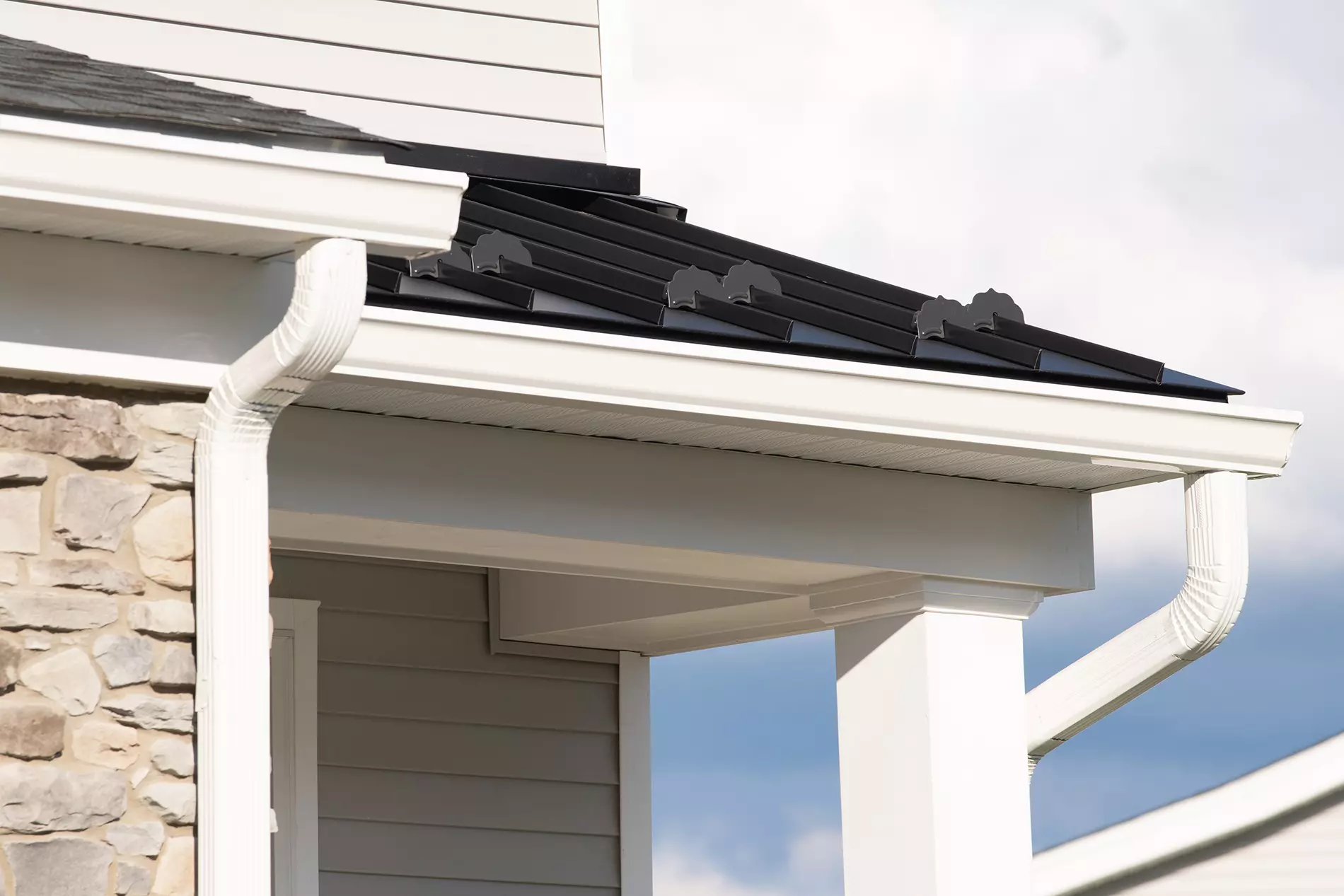 Side view of a home showcasing gutters